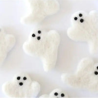Thumbnail for White marshmallow ghosts with black eyes on a white background